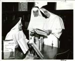 Adrian Dominican Sisters reviewing books in the library